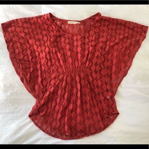 Anthropologie The Addison Story brand orange-rust blouse, size Small.